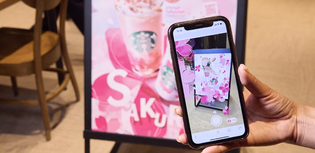 A representative AR poster: Starbucks Sakura AR, where scanning a QR code on the in-store poster triggers cherry blossoms
