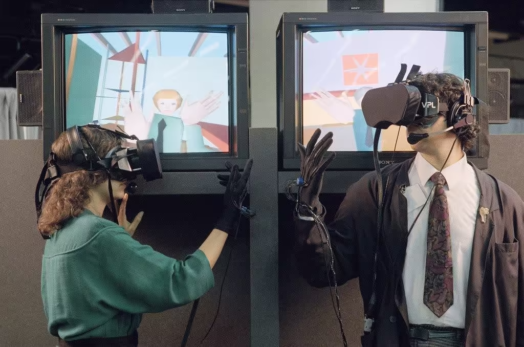 Two people demonstrate the VPL EyePhone HMD and DataGlove (June 7, 1989)